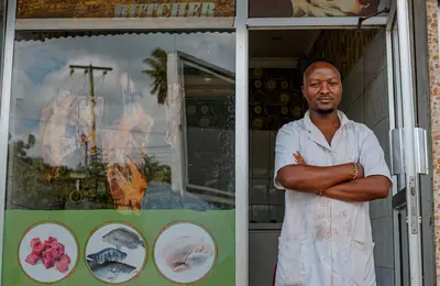 Shop owner standing at his store entrance