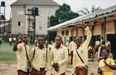 School students in uniform outside their school